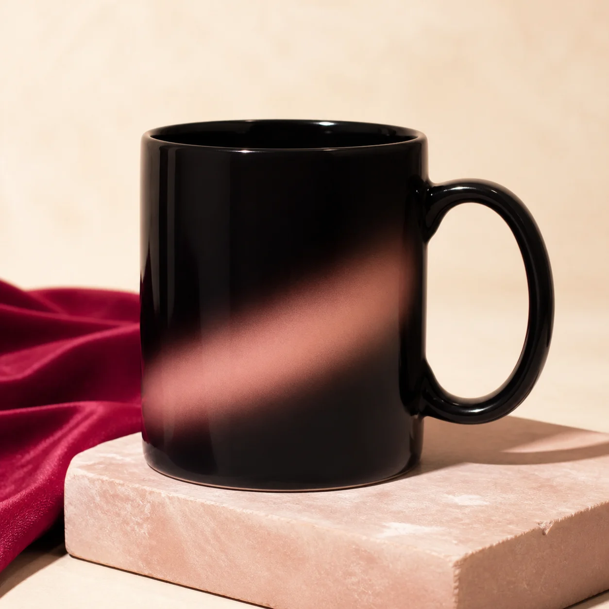 A blank glossy black heat-reactive mug with a subtle blush reveal glow